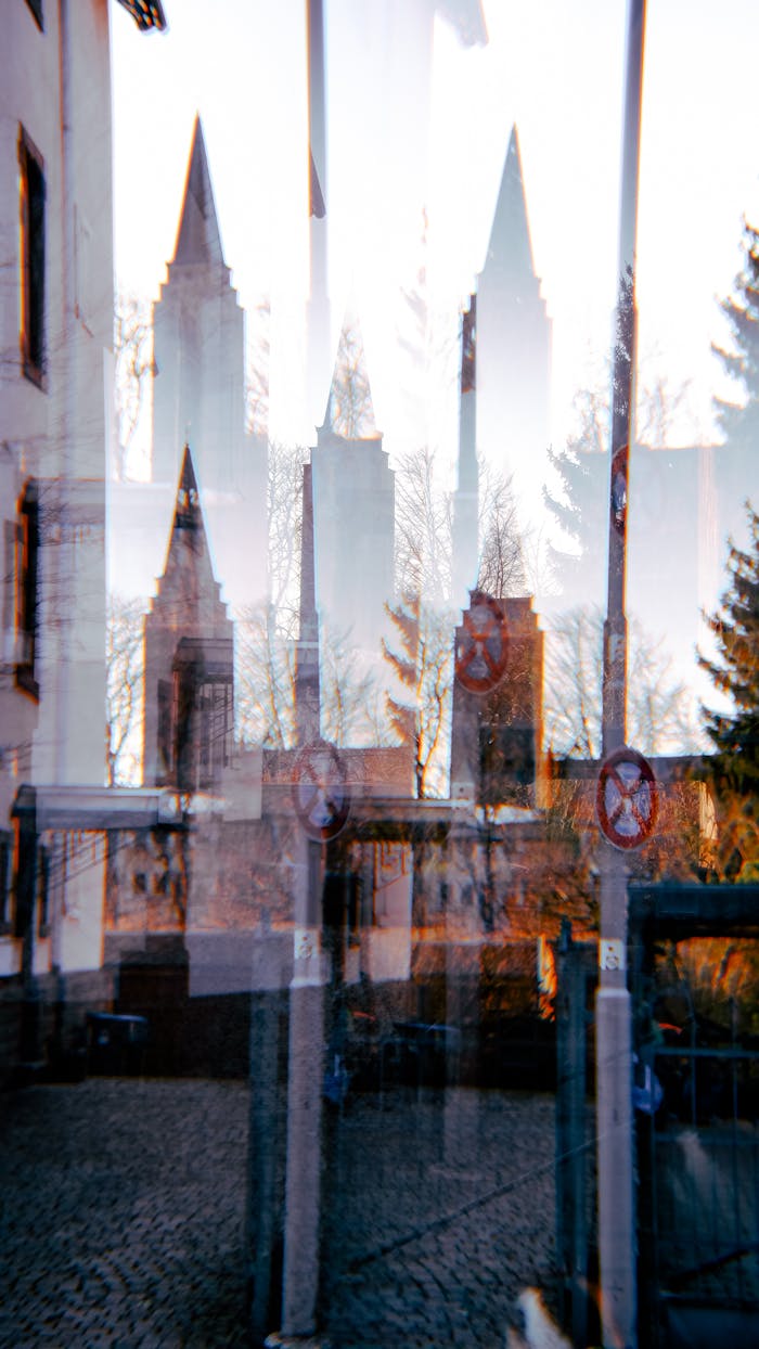Blurred reflection of city towers in urban scene, showcasing architectural depth and artistic flair.